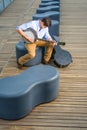 Young man sitting outside, playing music Royalty Free Stock Photo