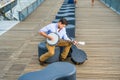 Young man sitting outside, playing music Royalty Free Stock Photo