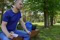 The young man sitting in the Park on a bench sad and tired, looked down. Royalty Free Stock Photo