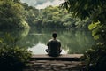 Young man sitting peacefully by tranquil lake. Generative AI