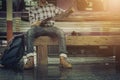 Young man sitting read map and travel bag at the train station Royalty Free Stock Photo