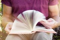 Young man is sitting and reading a book Royalty Free Stock Photo