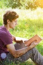 Young man is sitting and reading a book Royalty Free Stock Photo