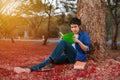 Young man sitting and reading a book in park Royalty Free Stock Photo