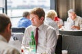 Young man sitting in restaurant on event party Royalty Free Stock Photo