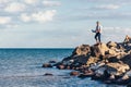 Young man sitting on a rock ad using laptop Royalty Free Stock Photo