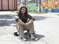 Young Man Sitting On Skateboard Royalty Free Stock Photo