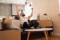 Young man sitting on sofa and joyfulling at home Royalty Free Stock Photo