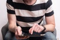 young man sitting on sofa using digital tablet. Home work or study, freelance, online shopping, distance education Royalty Free Stock Photo