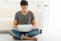 young Man sitting in sofa and using laptop Royalty Free Stock Photo