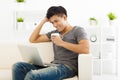 young Man sitting in sofa and using laptop Royalty Free Stock Photo