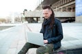 Young man sitting on the stairs using laptop Royalty Free Stock Photo