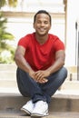 Young Man Sitting On Steps Of Building Royalty Free Stock Photo