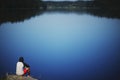 Young man sitting on the stone enjoying peaceful moment Royalty Free Stock Photo