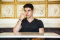 Young Man Sitting at Table Picking Nose Royalty Free Stock Photo