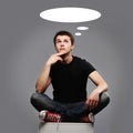 Young man sitting and thinking about something Royalty Free Stock Photo