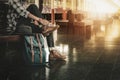 Young man sitting Tie his shoes and travel bag at the train stat Royalty Free Stock Photo