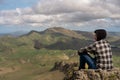 Young man sitting at the top of the mountain in Te Mata Park, Hawke`s Bay, New Zealand Royalty Free Stock Photo