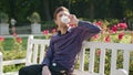 Young Man Having a Coffee in the Park Royalty Free Stock Photo