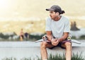 Young man, skateboard and relax outdoor, thinking or chill being casual, trendy and earphones. Mockup, male skater or Royalty Free Stock Photo