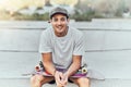 Young man, skateboard and skater with music at urban skate park, youth and recreation with earphones for audio streaming Royalty Free Stock Photo