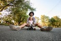 Young man skater resting sitting on skateboard with girl Royalty Free Stock Photo