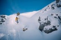 Young man skiing down a snowy mountain slope