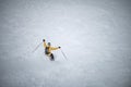 Young man skiing down a snowy mountain slope