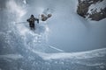 Young man skiing down a snowy mountain slope