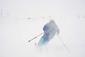 Young man skiing in snowstorm Royalty Free Stock Photo