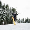 Young man on skis doing tricks at ski resort. Royalty Free Stock Photo