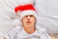 Young Man sleep in Santa Hat