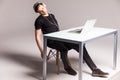 Young man sleep while wearing headphones and work on laptop on his office table on white background. work Royalty Free Stock Photo