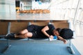 Young handsome man sleeping at the airport while waiting for delayed flights Royalty Free Stock Photo