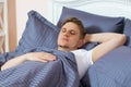Young man sleeping in bed alone at home Royalty Free Stock Photo