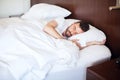 Young man sleeping in a bed