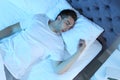 Young man sleeping in bed at night Royalty Free Stock Photo