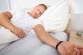 Young Man Sleeping On Bed Wearing Smart Wristband