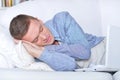 Young man sleeping in front of laptop Royalty Free Stock Photo
