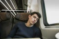 Young man sleeping while traveling on a train Royalty Free Stock Photo