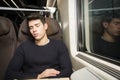 Young man sleeping while traveling on a train Royalty Free Stock Photo