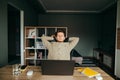 A young man sleeps on a break between freelance work remotely on a computer over the internet. Freelancer sleeps in a chair at