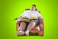 Young man sleeps with junk foods on the armchair Royalty Free Stock Photo