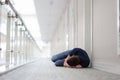 Young man sleeps under door of hotel complex