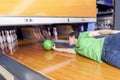 Young man sliding down a bowling alley