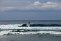 Young man sliding down a wave on a yellow surfboard. Surfer on a yellow surfboard on the crest of the wave. Young surfer learns to Royalty Free Stock Photo