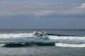 Young man sliding down a wave on a yellow surfboard. Surfer on a yellow surfboard on the crest of the wave. Young surfer learns to Royalty Free Stock Photo