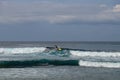 Young man sliding down a wave on a yellow surfboard. Surfer on a yellow surfboard on the crest of the wave. Young surfer learns to Royalty Free Stock Photo