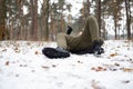 Young man slipped and lost his balance during a walk on a birch grove in winter. Royalty Free Stock Photo