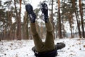 Young man slipped and lost his balance during a walk on a birch grove in winter. Royalty Free Stock Photo